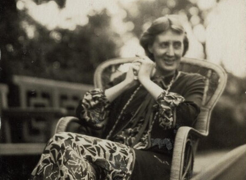 Uma fotografia sépia de Virginia Woolf sorrindo.