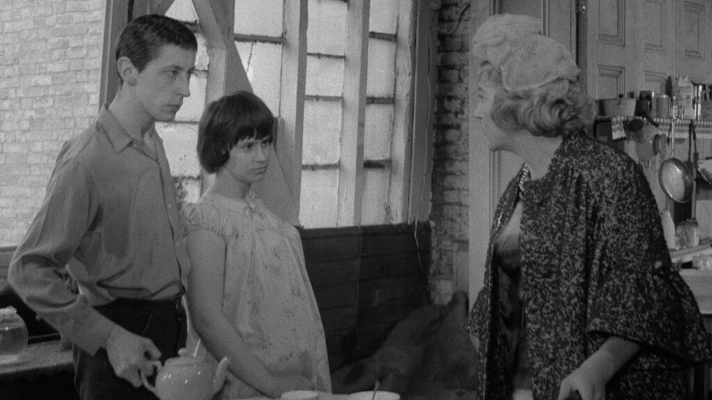 Cena da adaptação para o cinema de "A Taste of Honey". Na imagem, Jo e Geoffrey estão frente à Helen em um momento de visível tensão.